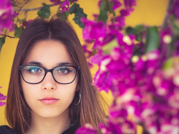 Woman on background of stunning violet flowers