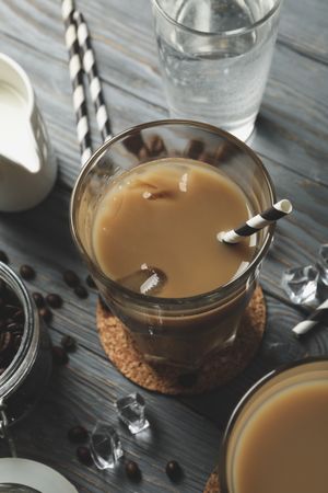 Composition with glasses of ice coffee on wooden background