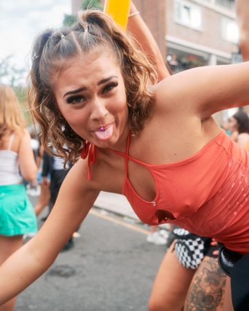 London, England, United Kingdom - August 28, 2022: Woman with pierced tongue dancing outside