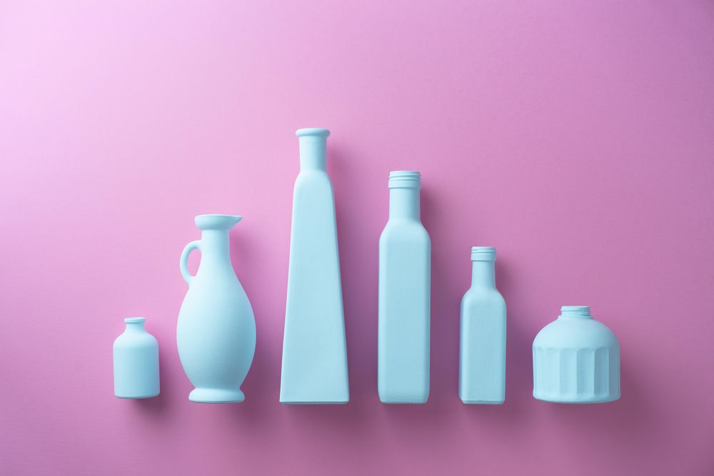 Painted glass bottles on purple background
