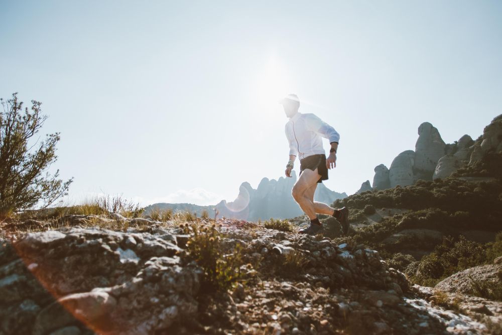 Man running on rugged terrain