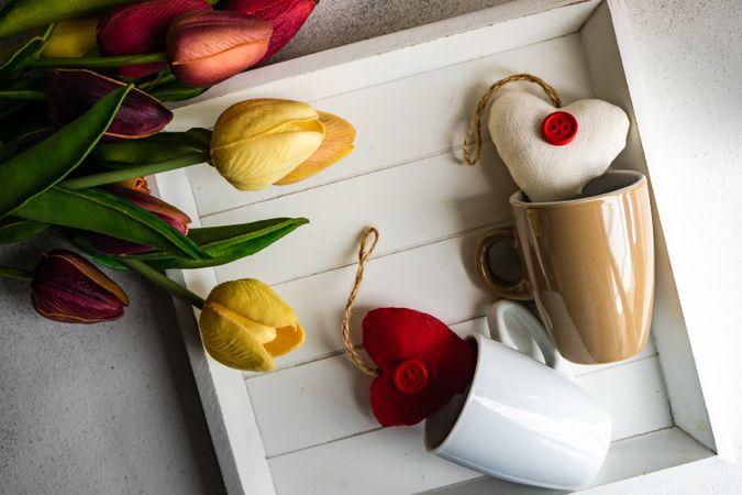 St. Valentine's Day card with mugs, heart ornaments and tulips