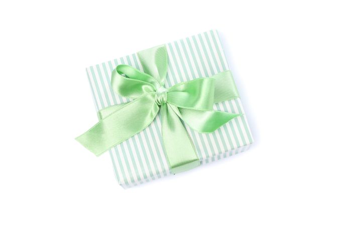 Gift box with green bow isolated on blank background