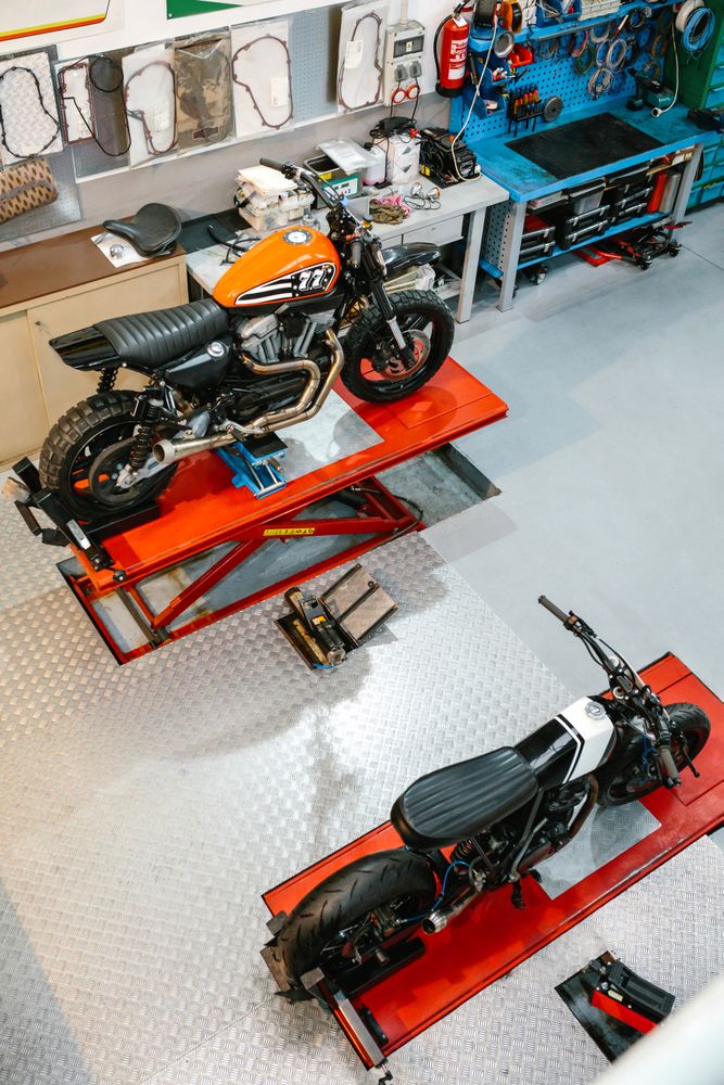 Top view of empty motorcycle workshop with custom motorbikes over platforms ready to review