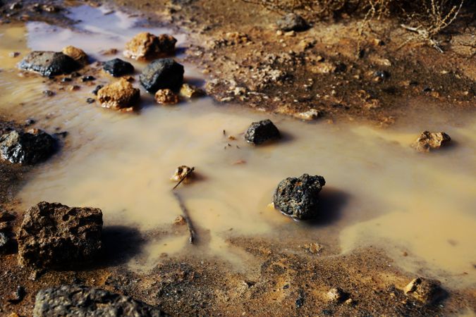 Dirty clay water with rocks