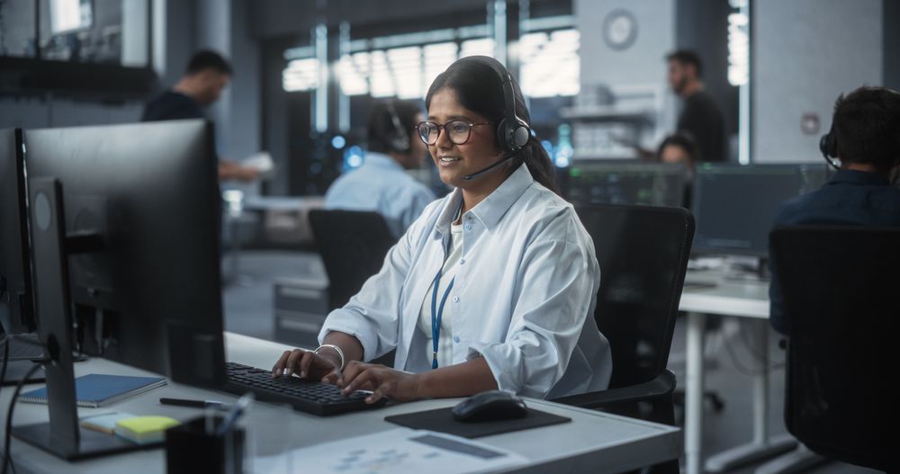 Positive Technical Support Manager Talking on a Call, Providing Help Desk Solutions to a Customer Experiencing Troubleshooting Issues with a Product.