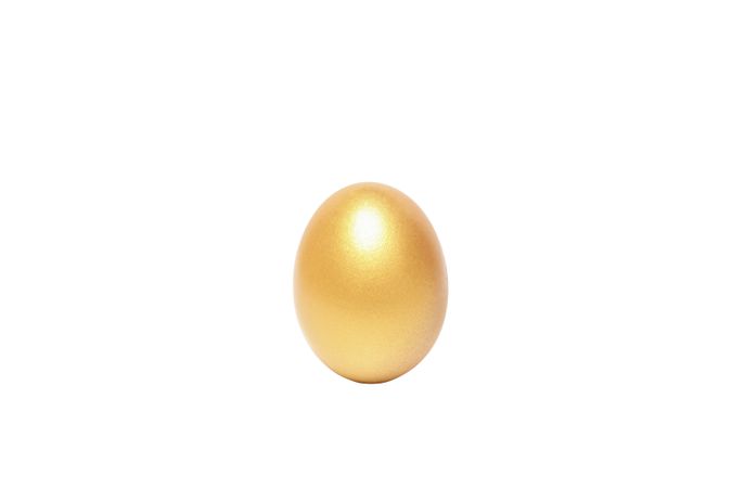 Concept of wealth and retirement - golden eggs, isolated on light background