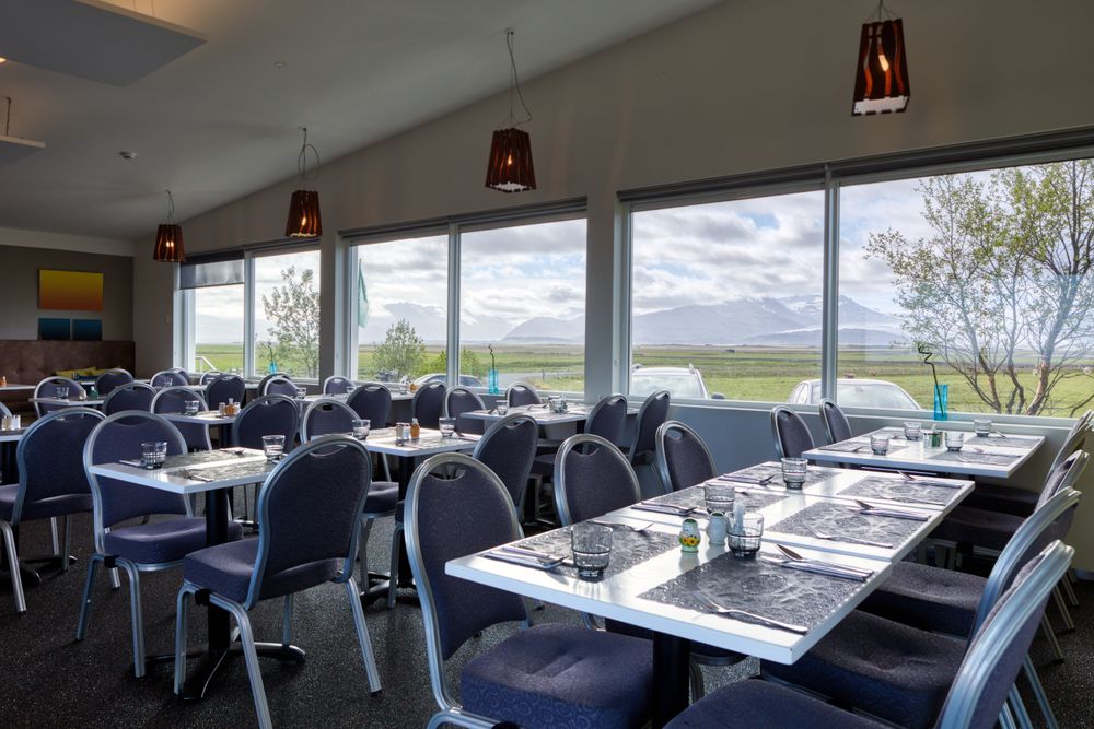 Dinning room with wonderful view of summer mountain landscape from window in hotel