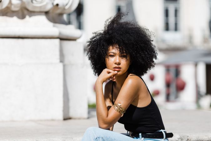 Black female siting on stairs outdoors