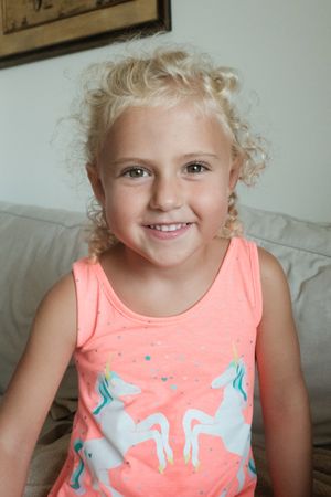 Delighted preteen girl in living room