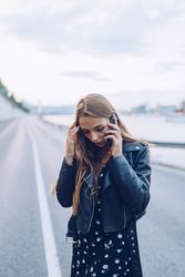 Long haired stylish woman speaking on smartphone