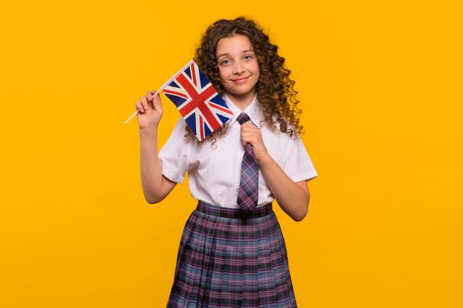 Smiling girl holding a UK flag