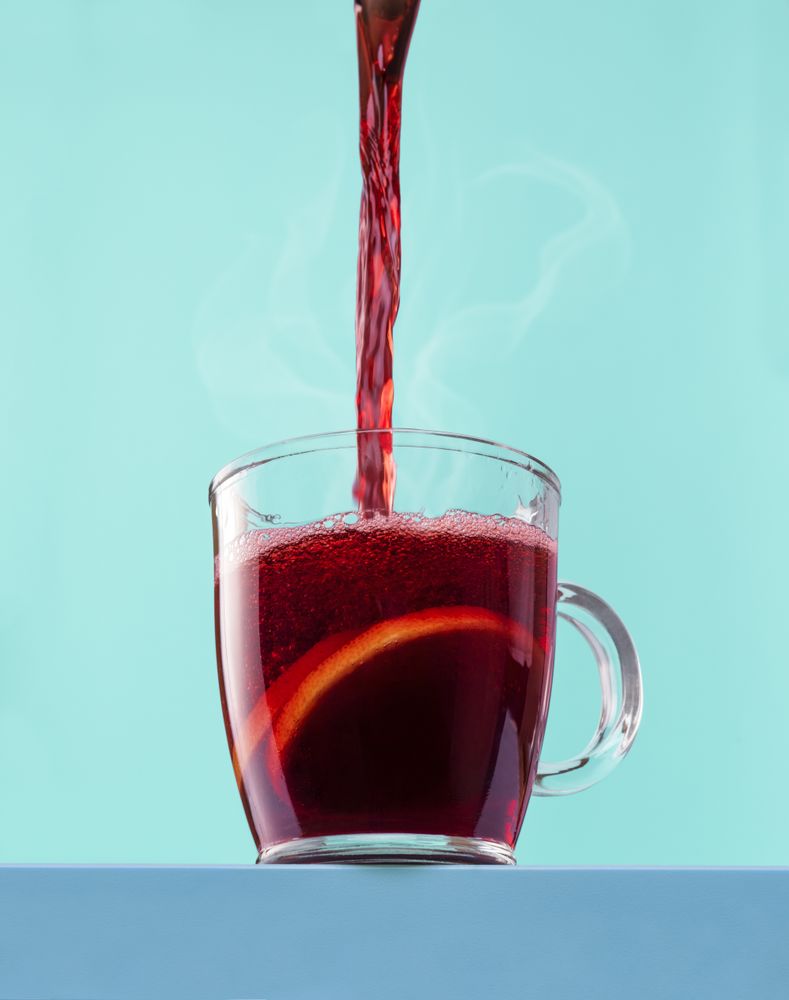 Pouring hot mulled wine into the cup