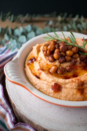 Rosemary sprig on pepper hummus