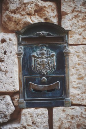 Post box embedded in wall with Coat of Arms