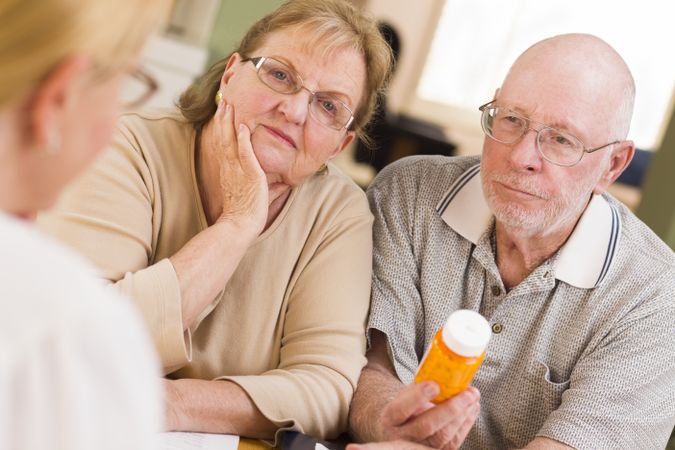 Doctor or Nurse Explaining Prescription Medicine to Older Couple