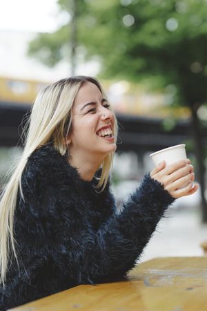 woman drinking coffee in street cafe