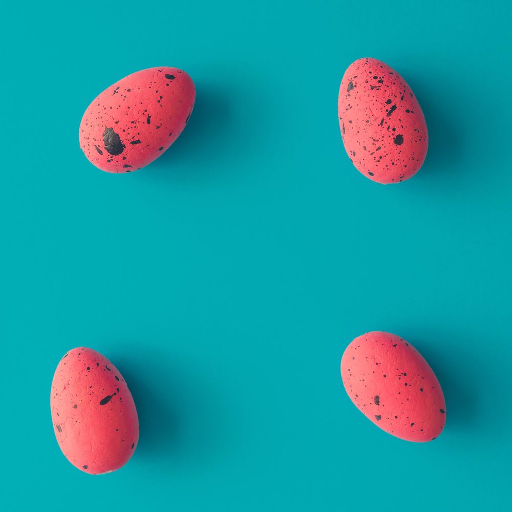 Bright pink Easter eggs on bright blue background