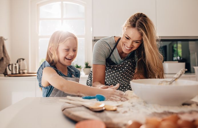 Beautiful mother and cute daughter baking in the morning time
