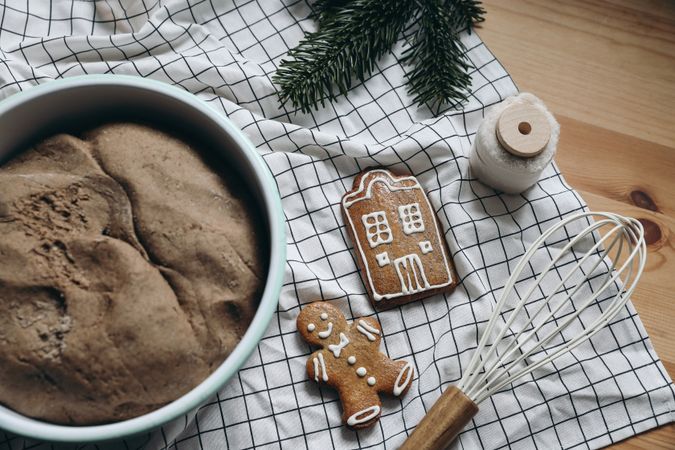 Gingerbread cookies, and cake with whisk on counter