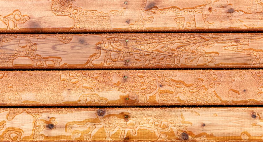 Top view of outdoor wooden stain deck boards with natural rain water