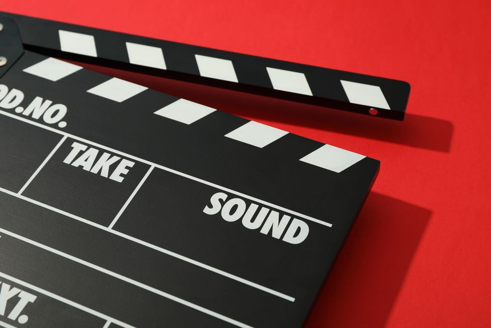 clapperboard on red background, space for text