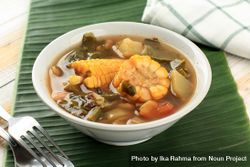 Bowl of Indonesian stew sayur asem on banana leaf 5QEpd5