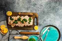 Top view of fresh lemon cake on kitchen counter with space for text