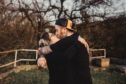 Young couple hugging and kissing in forest