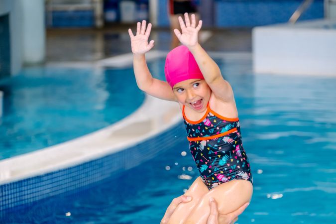 Mother playing with daughter in swimming pool
