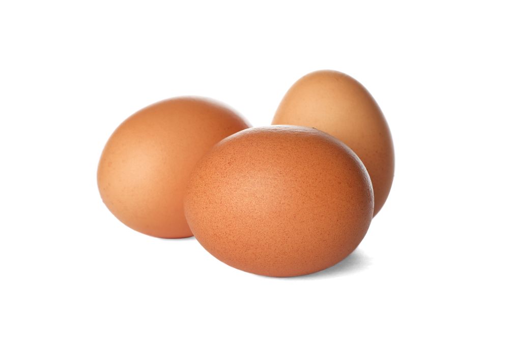 Few raw chicken eggs on plain background