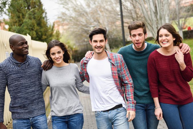 Friends going for a stroll together on path outside