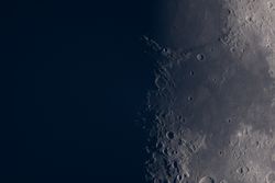 Close-up view of the moon's craters along lunar terminator.