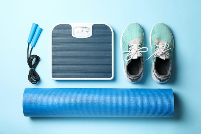 Weight loss or healthy lifestyle accessories on blue background