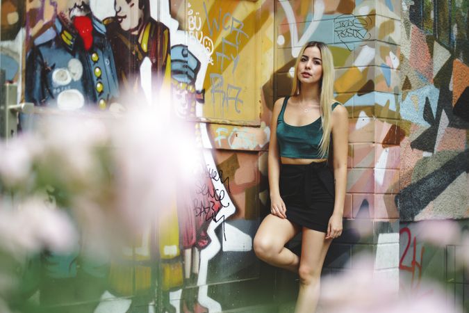 blonde model leaning on street wall