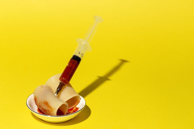Stuffed pasta with red sauce in syringe