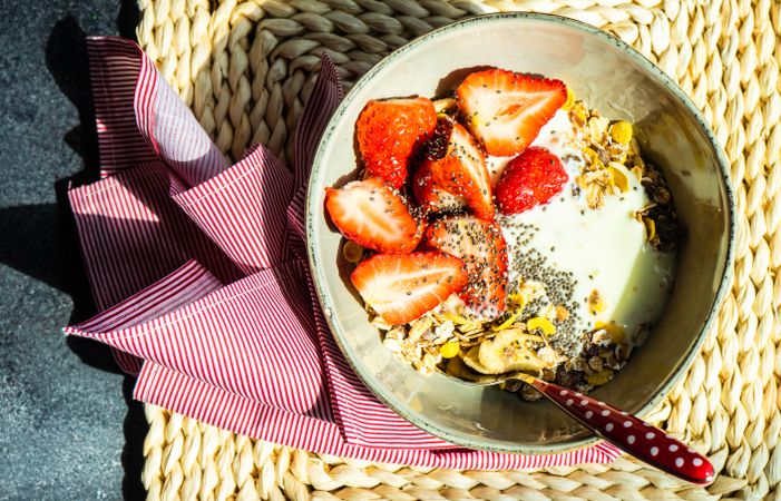 Top view of healthy breakfast bowl with oatmeal and strawberry