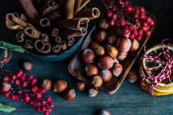 Top view of hazelnuts and cinnamon sticks on table