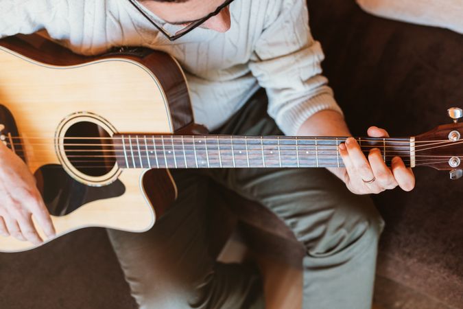 Man playing the guitar at home