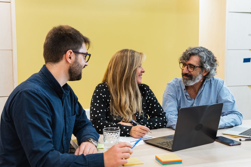 Cheerful colleagues working together on project in office