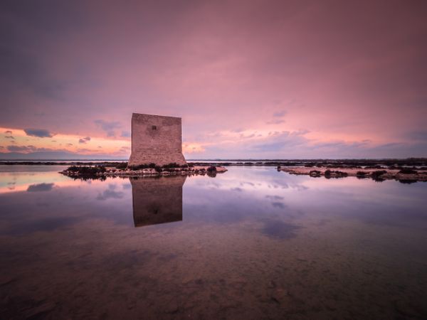 Wonderful watchtower in calm lake on cloudy day