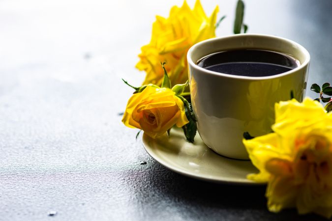 Cup of coffee and yellow roses