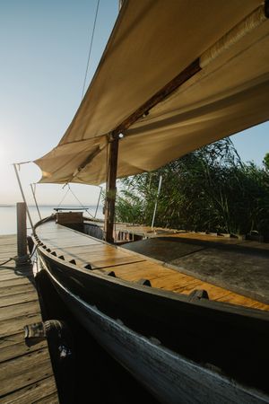 Moored boat by wooden pier