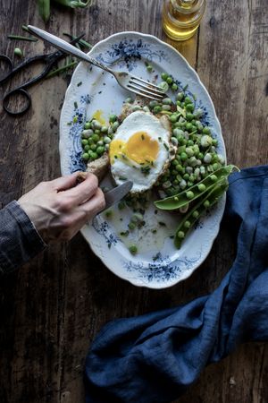 Delicious breakfast meal with steamed peas and egg