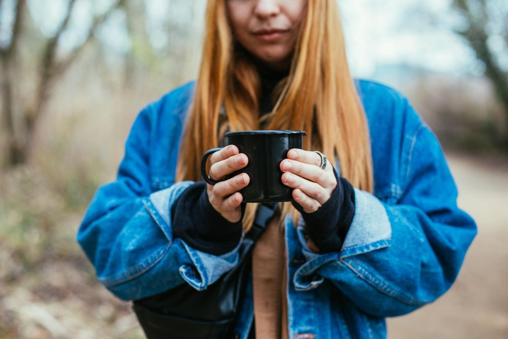 Woman holding up mug of coffee