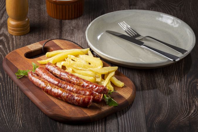 Grilled German sausage with french fries.