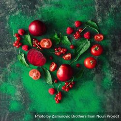 Heart shape made of red healthy food, fruits, and vegetables with green leaves 5RdYDb