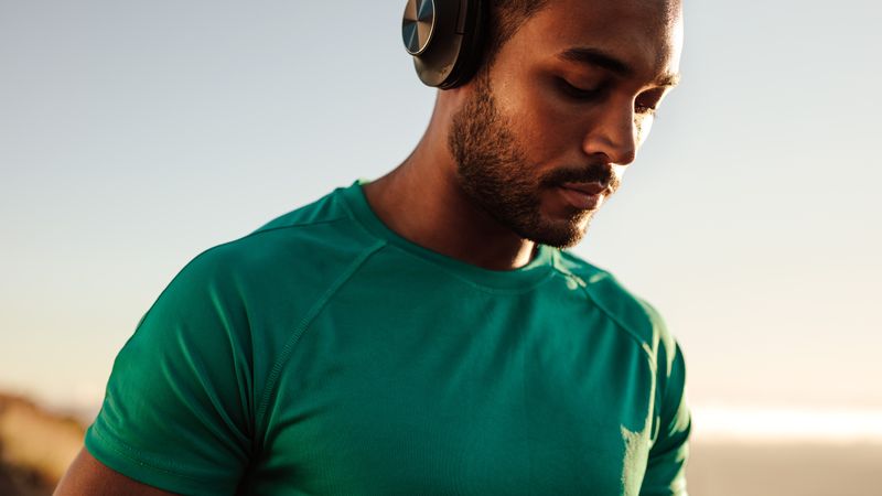 Close up of an athlete standing outdoors wearing headphones