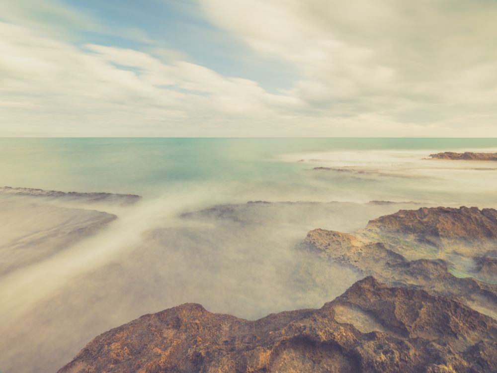 Rocky seashore under blue sky