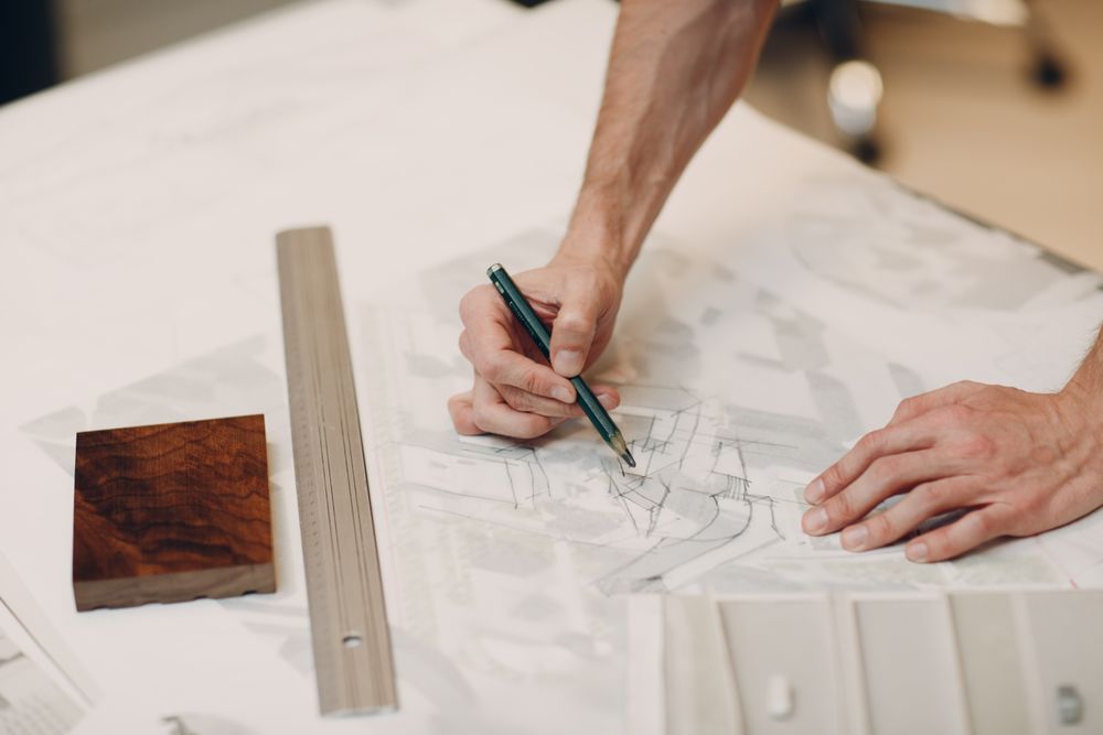 Cropped image of hands of architect drawing on a paper